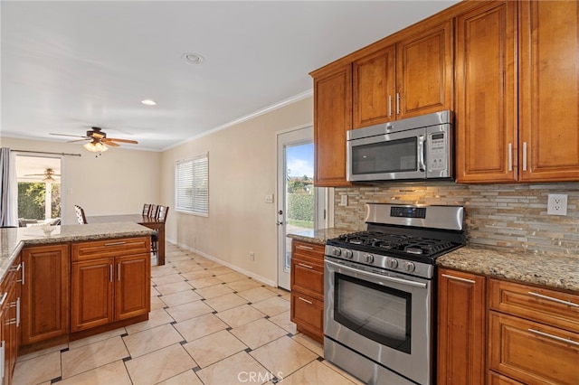 kitchen featuring appliances with stainless steel finishes, brown cabinetry, and backsplash