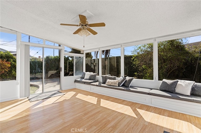 unfurnished sunroom with ceiling fan and a wealth of natural light