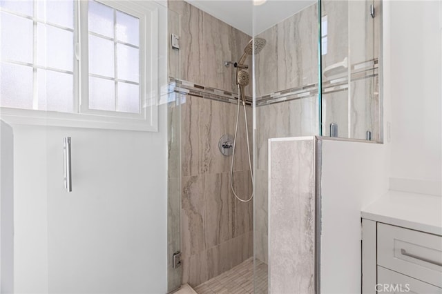 full bath with a shower stall and vanity