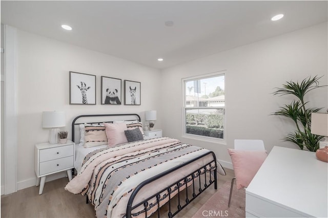 bedroom with light wood-type flooring, baseboards, and recessed lighting