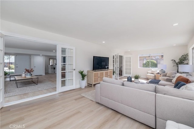 living room featuring light wood finished floors, french doors, and recessed lighting