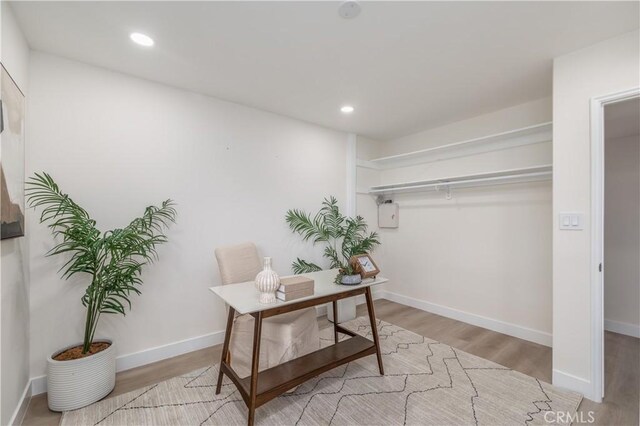 office space with baseboards, wood finished floors, and recessed lighting