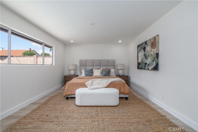 bedroom featuring light wood-type flooring, baseboards, and recessed lighting