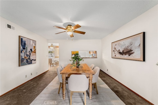 dining area featuring ceiling fan, carpet, visible vents, and baseboards