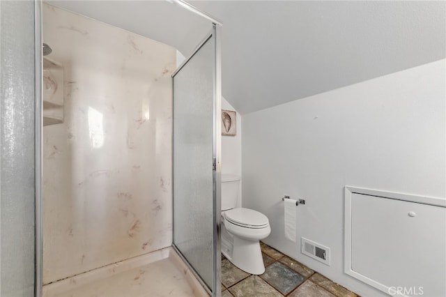 bathroom with vaulted ceiling, visible vents, a stall shower, and toilet