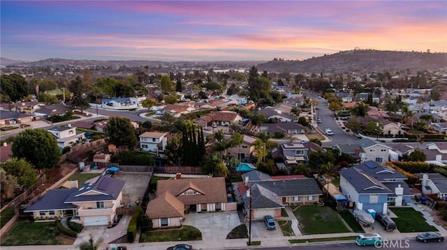 aerial view at dusk featuring a residential view