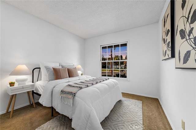 bedroom featuring a textured ceiling, baseboards, and carpet flooring