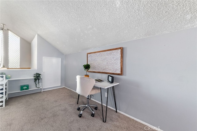 office area featuring lofted ceiling, a textured ceiling, carpet flooring, and baseboards