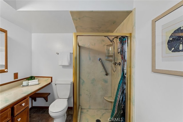 bathroom with toilet, a stall shower, vanity, tile patterned flooring, and baseboards