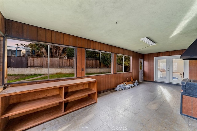 unfurnished sunroom with french doors