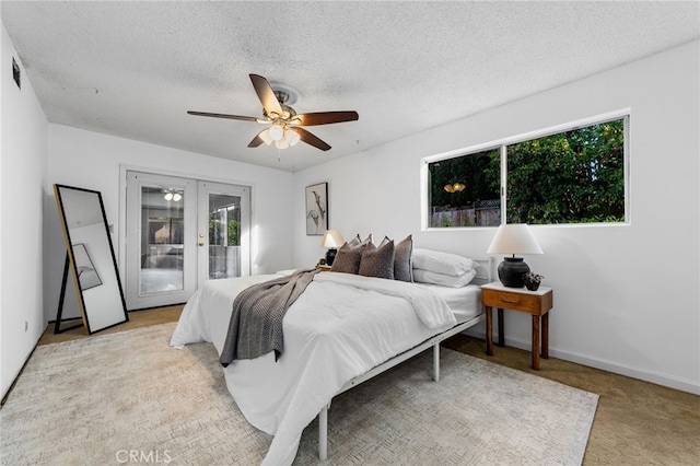 bedroom featuring access to exterior, french doors, light colored carpet, ceiling fan, and a textured ceiling