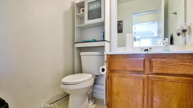 half bath featuring toilet and vanity