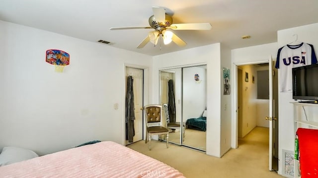 bedroom featuring a ceiling fan, a closet, light colored carpet, and visible vents