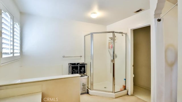 full bathroom with a stall shower, visible vents, and a bath