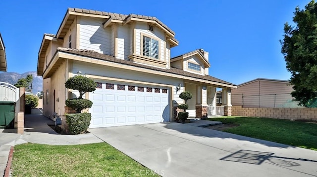 traditional-style house with driveway, a garage, and fence