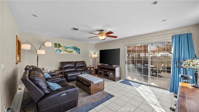 living room with a ceiling fan, visible vents, and tile patterned flooring