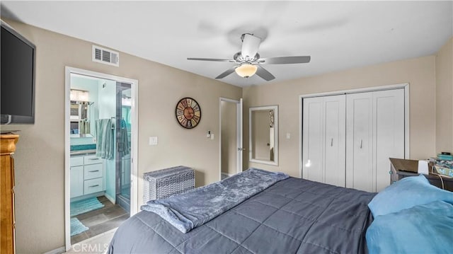 bedroom with visible vents, a closet, wood finished floors, ensuite bathroom, and a ceiling fan