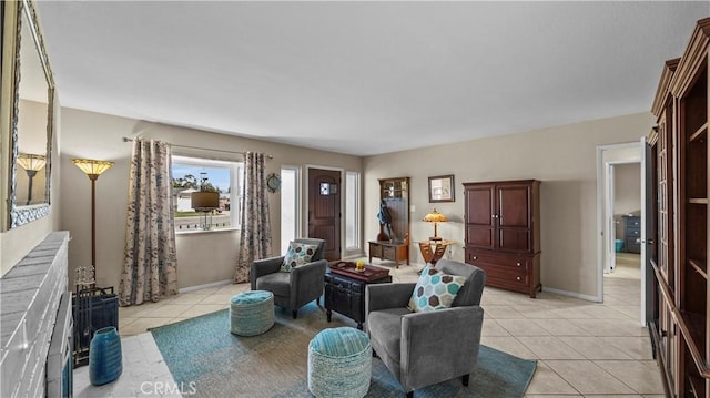 living room with light tile patterned floors and baseboards
