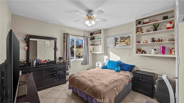 bedroom featuring a ceiling fan and light tile patterned floors