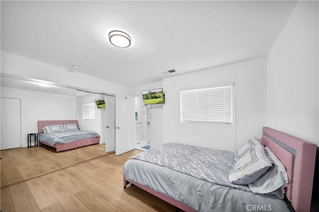 bedroom with wood finished floors and visible vents