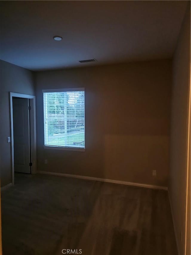 spare room with visible vents and baseboards