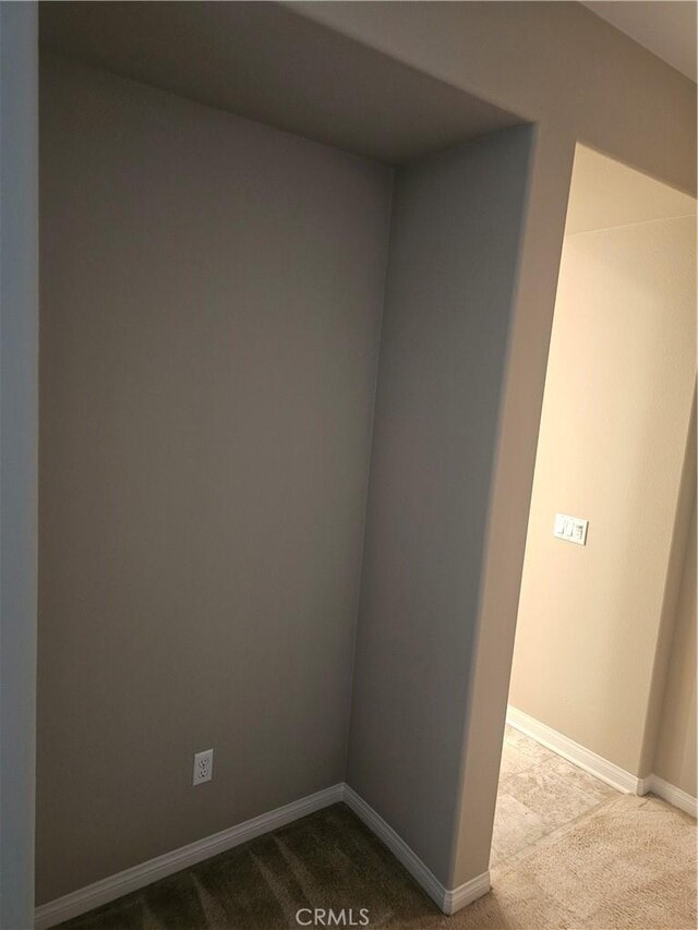 carpeted spare room with baseboards