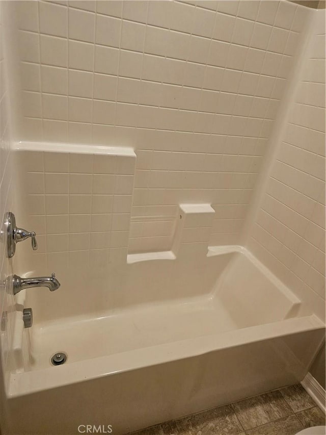 bathroom with tile patterned floors and shower / bathtub combination