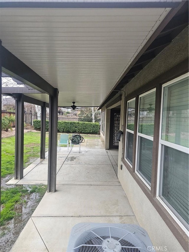 view of patio with a ceiling fan, central AC, and fence