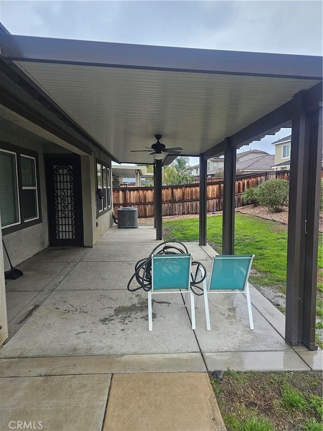 view of patio with ceiling fan and fence