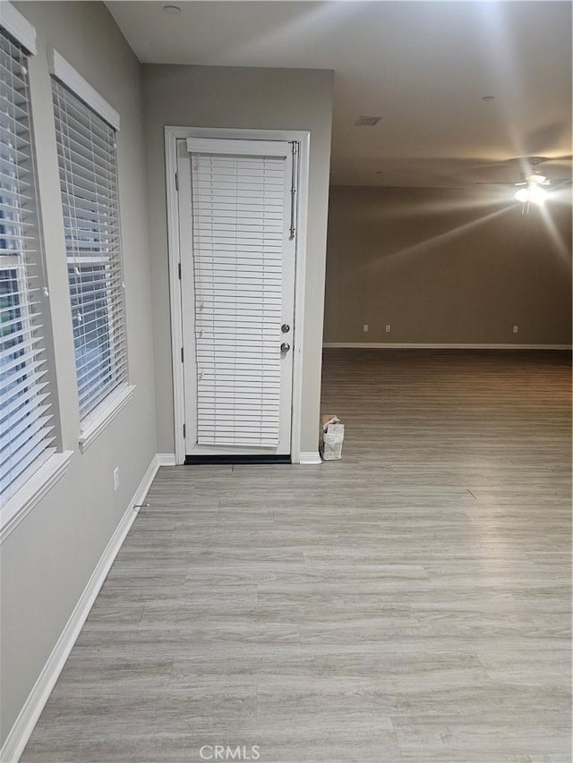 interior space with wood finished floors and baseboards