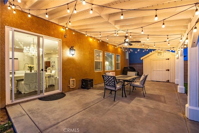 view of patio / terrace with an outbuilding, outdoor dining space, and a storage shed