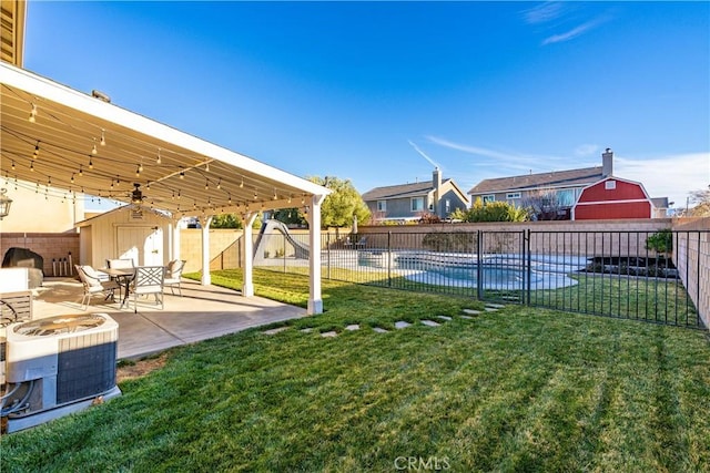 view of yard with a fenced in pool, a patio area, a fenced backyard, and central air condition unit