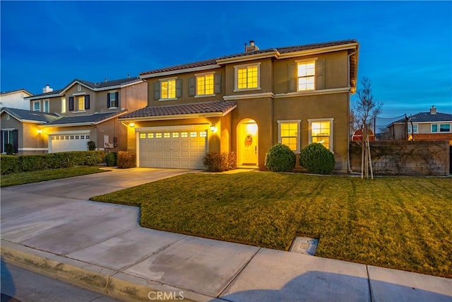 view of front of house featuring a garage, concrete driveway, stucco siding, a tiled roof, and a front yard