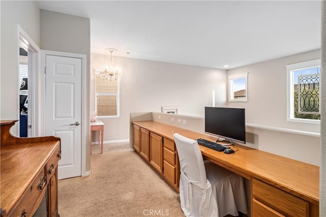 office area featuring light colored carpet, baseboards, and an inviting chandelier