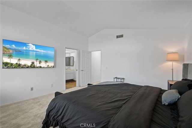 carpeted bedroom featuring vaulted ceiling, ensuite bath, and visible vents