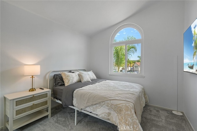 carpeted bedroom with baseboards and vaulted ceiling