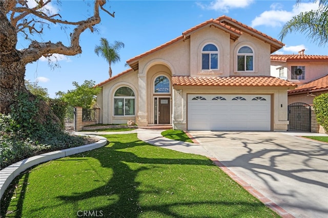 mediterranean / spanish house featuring a gate, fence, concrete driveway, and stucco siding