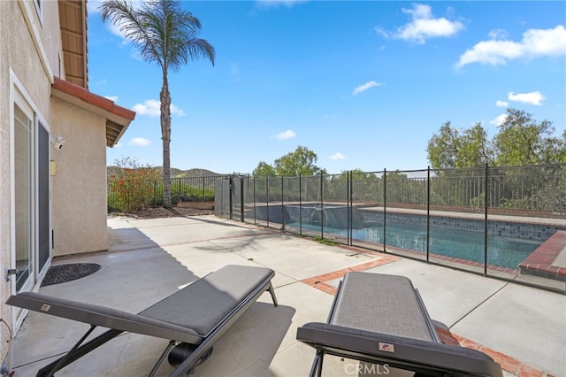 view of swimming pool with a fenced backyard, a fenced in pool, and a patio