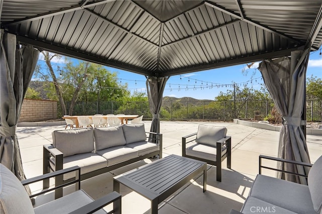 view of patio / terrace with outdoor lounge area, a fenced backyard, and a gazebo