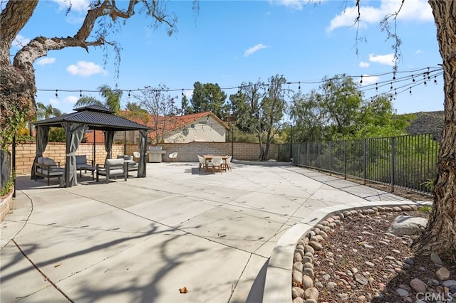 view of patio featuring a fenced backyard and a gazebo