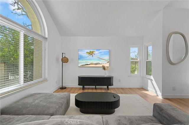 sitting room with vaulted ceiling, wood finished floors, and baseboards