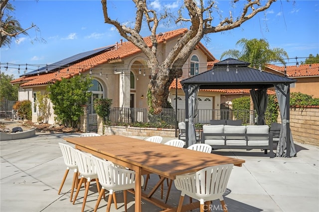 view of patio / terrace with an outdoor hangout area, a gazebo, outdoor dining space, and fence