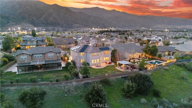 aerial view at dusk with a mountain view and a residential view