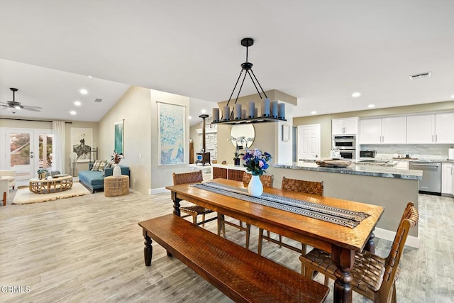 dining space featuring lofted ceiling, light wood-style flooring, recessed lighting, and visible vents