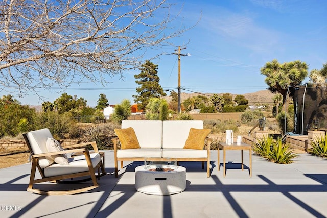 view of patio / terrace featuring an outdoor living space and fence