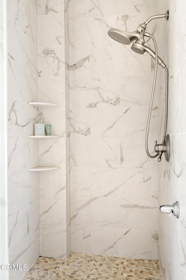 full bath featuring a marble finish shower