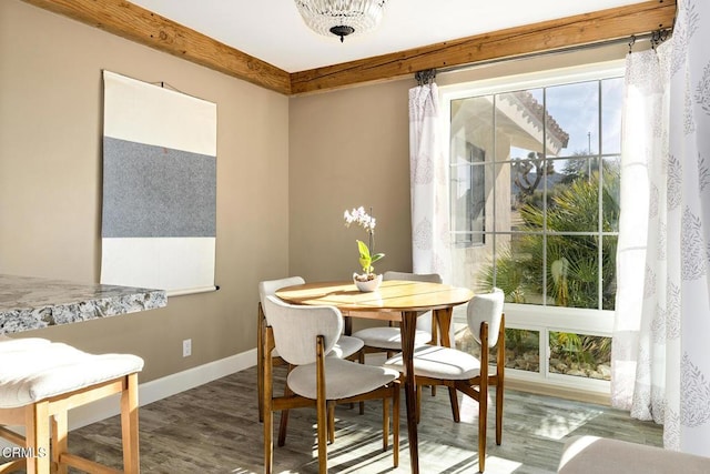 dining space with baseboards and wood finished floors