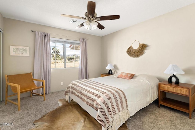 bedroom featuring a ceiling fan, visible vents, and carpet floors