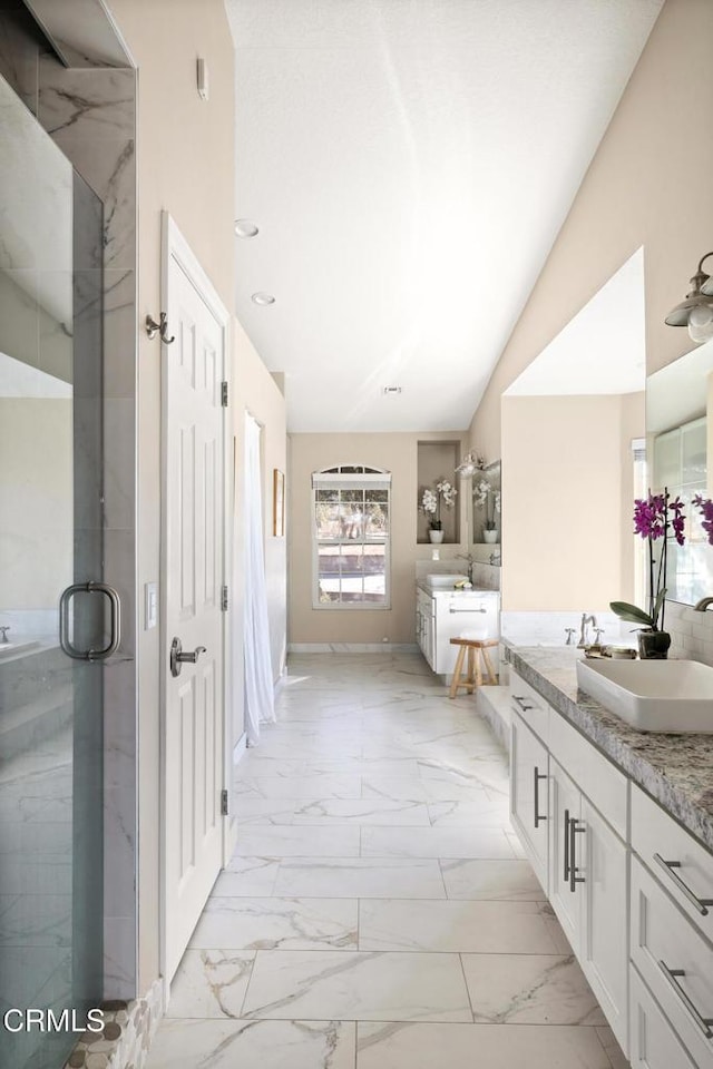 bathroom with vanity, baseboards, vaulted ceiling, a shower stall, and marble finish floor