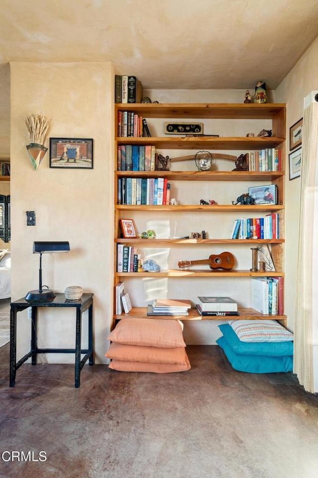 living area featuring concrete floors